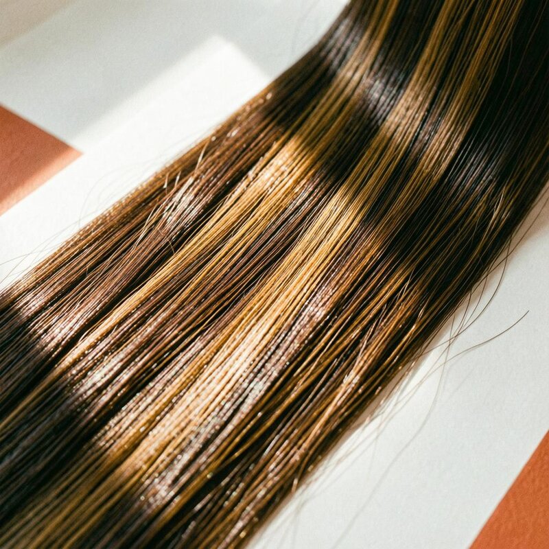 Long dark brunette extension hair blended in one smooth, glossy sheet