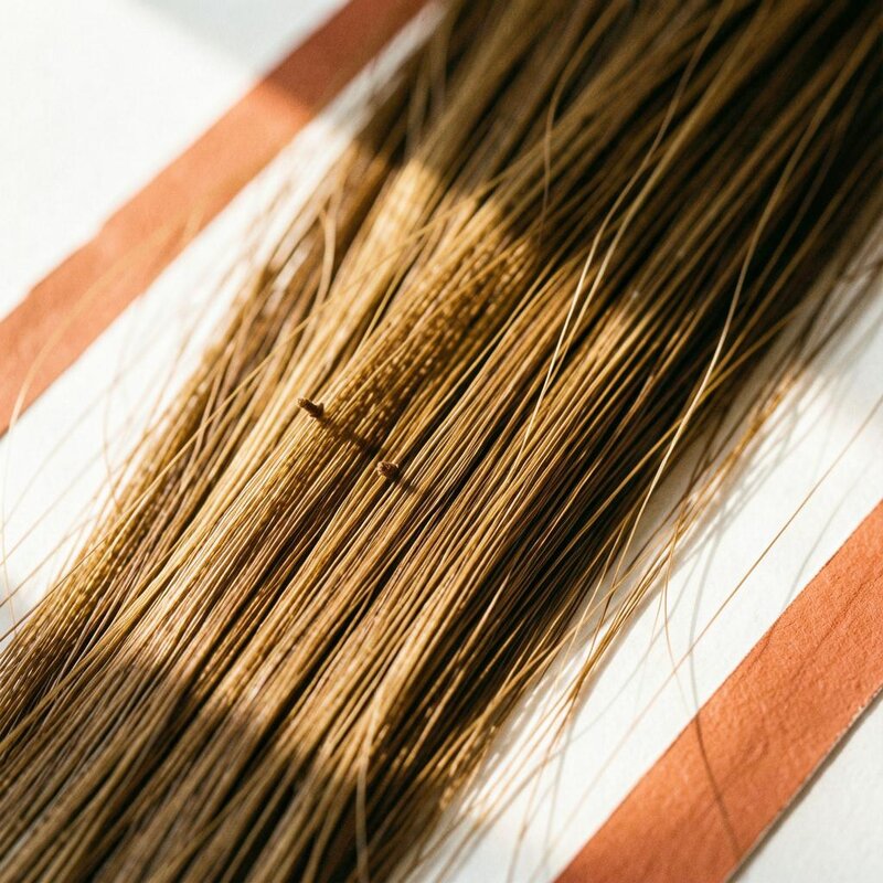 Fine light-brown hair strands with small keratin bond points