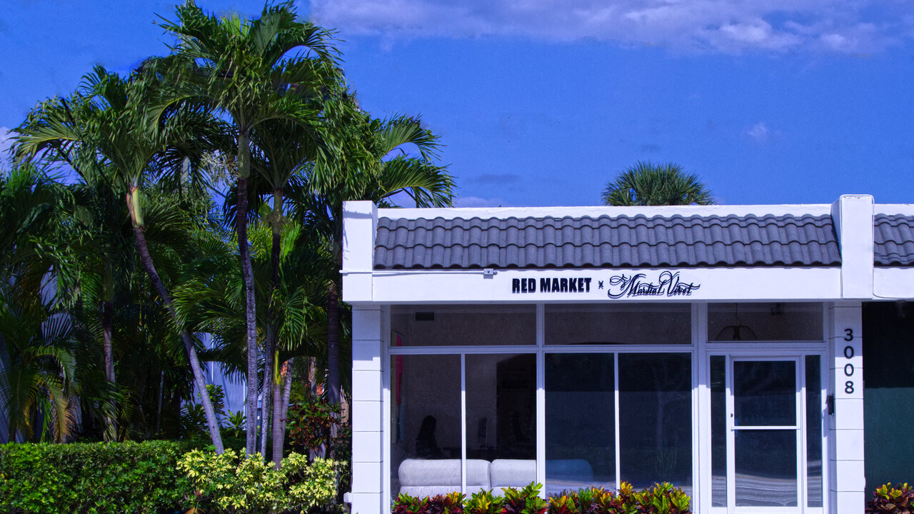Red Market & Martial Vivot storefront — 3008 S Dixie Hwy, West Palm Beach, palms and blue sky