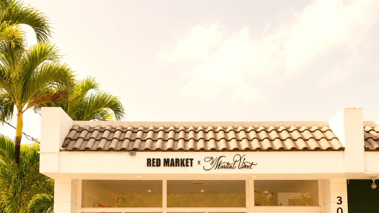 Red Market & Martial Vivot storefront — 3008 S Dixie Hwy, West Palm Beach, palm trees and a warm terracotta façade
