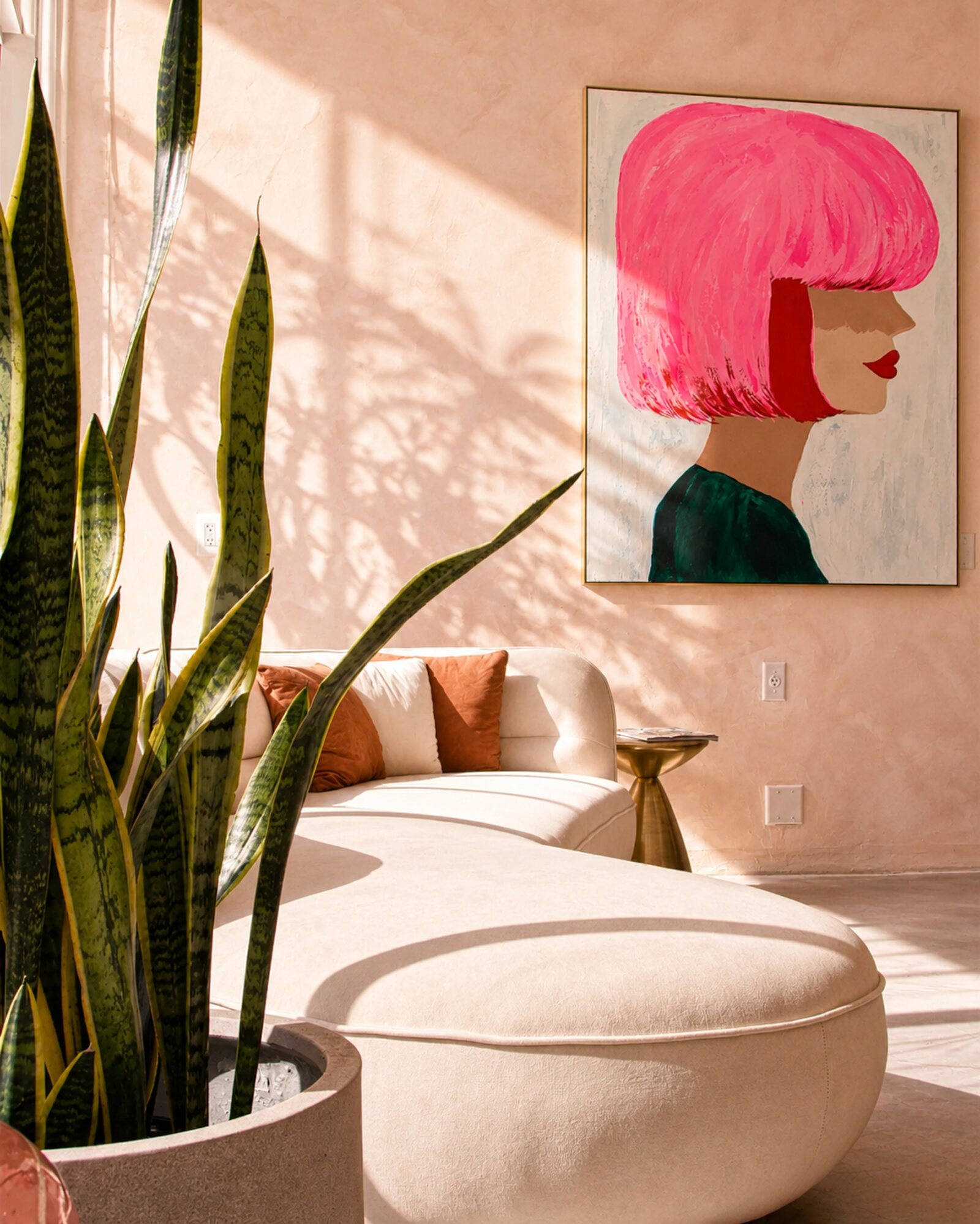Waiting area with a pink-bob art print at Red Market & Martial Vivot
